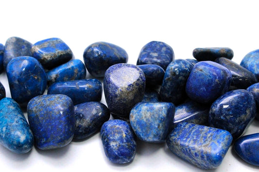 A pile of lapis lazuli stones with smooth surfaces